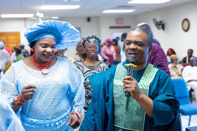 A man and woman leading worship with a microphone
