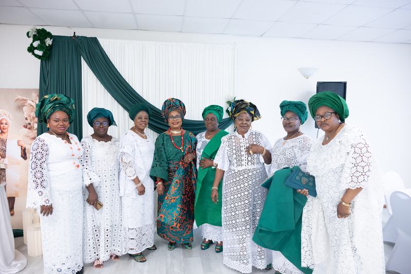 Women of the church in white lace and green headwraps